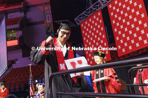 Zoyace Shrestha waves to family and friends after receiving his Engineering degree. Winter undergrad