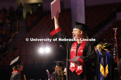 Jo Stollar waves to family and friends after receiving the diploma. Winter undergraduate commencemen