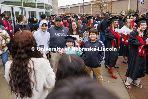 CEHS graduate Ruby Garcia Gonzalez is surrounded by family and friends for photos outside the arena 