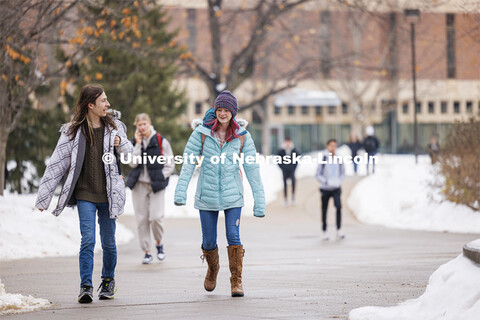 Elijah Brundage, left, and Ellie Fox walk across campus Tuesday. Snow on city campus. January 23, 20