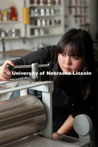 Amy Curtis, a junior in art, in printmaking class in Woods Art Building creates a printed piece. Jan