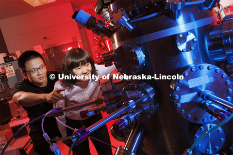 Xia Hong, right, and Yifei Hao look into a pressure vessel in Hong’s Jorgensen Hall lab. Hong’s 