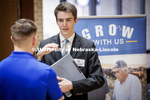 Ian Klaes talks with a recruiter from Farmers Cooperative in Dorchester, NE, at the East Campus Care