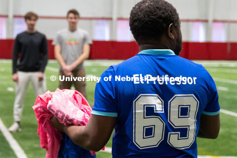 Professor Jean Marcel Ngoko Djiokap brings out the jerseys for the two teams at Cook Pavilion Field.