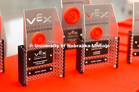 Competition trophies are lined up on a table. 2024 VEX Robotics Outreach Tournament hosted in Kiewit