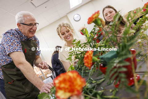 Professor Stacy Adams talks with Maddie Lind about adding to the symmetry of her bouquet. Adams teac