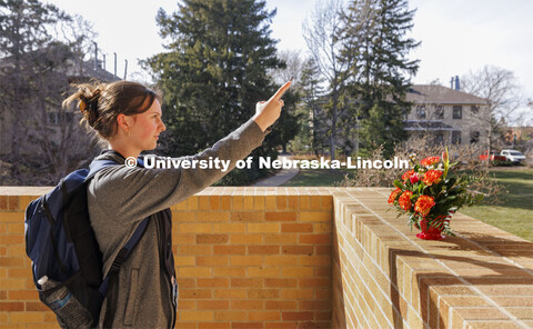 Chloe Waller takes a photo of her bouquet outside of the Plant Science Building after class.  Adams 