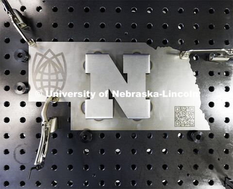 A metal sculpture that the robotic arm welded raised “N”. Nebraska Innovation Studio is working 