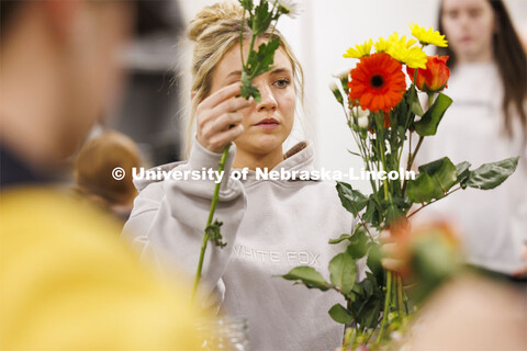 Emily Boyle, a senior Speech-Language Pathologist student designs her bouquet in PLAS 261 - Floral D