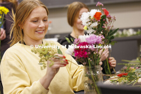 Sadie Jarecke, a junior Ag Leadership student designs her bouquet in PLAS 261 - Floral Design I in t