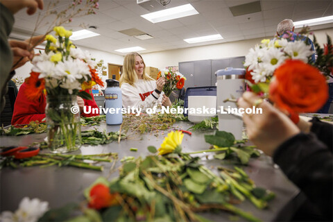 Emma Dostal, a senior Advertising and Public Relations student adds a flower to her bouquet in PLAS 