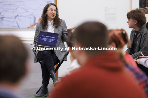 Katie Anania talks with students as they study in the in the Unprecedented: Art in Times of Crisis e