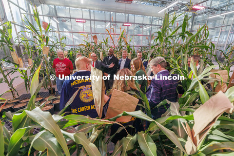 Governor Jim Pillen, at lower right, and others tour Nebraska Innovation Greenhouse following the Ag