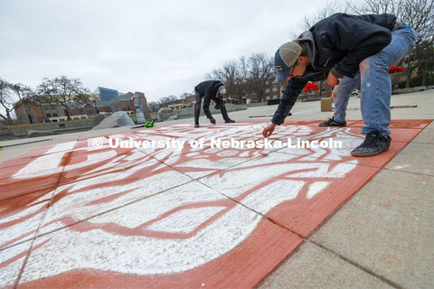 To welcome students for Admitted Student Day, designers Sam Sisco and Jesse Petersen chalk a mural o