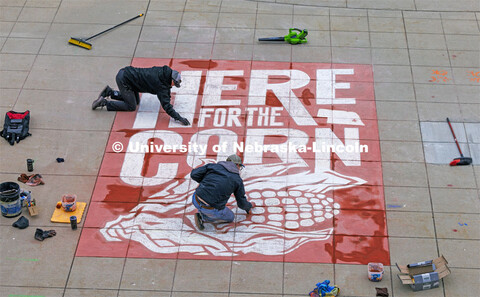 To welcome students for Admitted Student Day, designers Sam Sisco and Jesse Petersen chalk a mural o