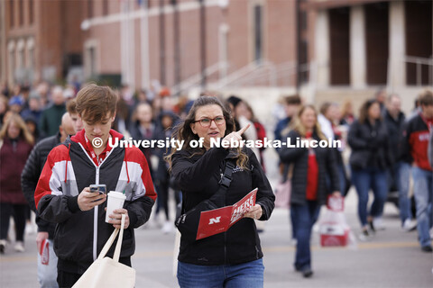 New students and parents leave the pep rally at the Coliseum and head toward their college admit soc