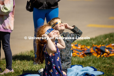 Kids join in on the fun wearing special glasses to see the eclipse at the East Campus' Solar Social.