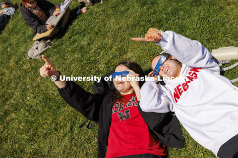 Julia Connealy and Jesse Trout watch the eclipse from the greenspace on City Campus. The Solar Socia