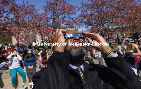 Chancellor Rodney D. Bennett watches the eclipse. The Solar Social party to view the partial solar e