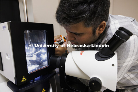 Eduardo Romero, Research Assistant Professor, loads a sample to be checked before being placed in th