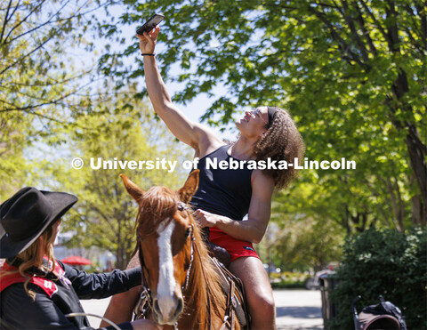 Josiah Allick takes a selfie as he rides Popsicle being led by Rodeo Club member Jaya Nelson. The Ne