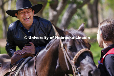 Hector Palala dismounts after receiving a ride on one of the rodeo horses. He borrowed the hat so he