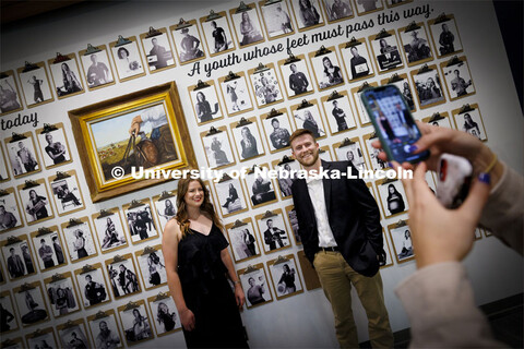 Alyssa Moser and Cole Kalkowski pose for a friend in front of their Engler portraits. The Engler Agr