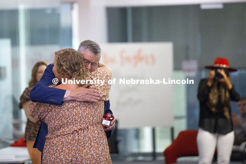 Tom Field hugs Vickie Ference, a junior in ag education. Ference won the "Fire In The Belly" award n