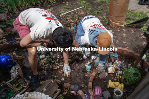 Delta Phi Fraternity’s Ben Huffer and Quinny Brumbaugh, clear away leaves and debris from a homeow