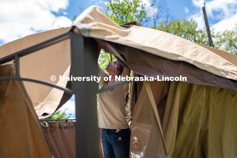 Tri Delta’s Rachel Nelson adjusts the roof of a pergola during the Big Event. May 4, 2024. 