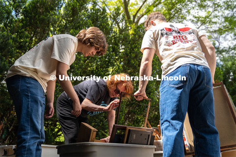 Phi Kappa Theta members Ryan Richert (left) and Alex Buescher (right) sort through a tub of picture 