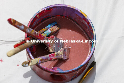 A bucket of water holds used paintbrushes. ARTS 398 - Special Topics in Studio Art III taught by San