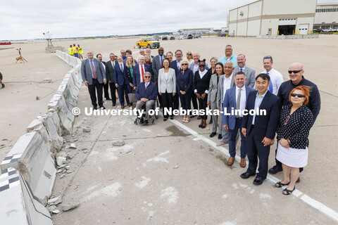 The group who witnessed the test poses in the area where the barrier deflected after being struck by