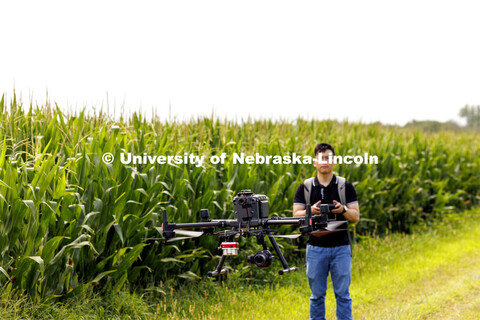 Biquan Zhao, Post-Doc Research Associate in Animal Science, flies a drone over the corn fields north