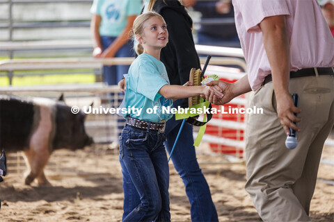 Emma Peterson of Osceola, Nebraska, shakes hands with the judge after being awarded the reserve gran