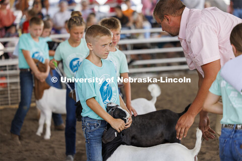 Jeter Zelasney listens to goat judge John Alfs talk about his goat in the Meat Goat Junior Showmansh