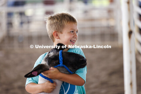 A young boy hugs his sheep. 4-H Polk County Fair in Osceola, Nebraska. July 19, 2024. 