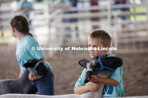 A young boy hugs his sheep. 4-H Polk County Fair in Osceola, Nebraska. July 19, 2024. 