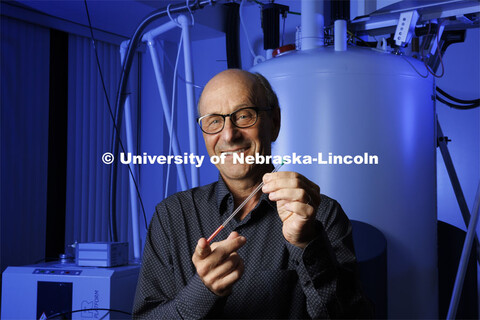 David Berkowitz holds an NMR tube, preparing to analyze the structure of a compound synthesized in h