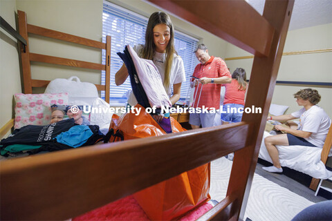 Abby Roberts of Elkhorn unpacks her Suites Residence Hall room. Move in began today as designated gr