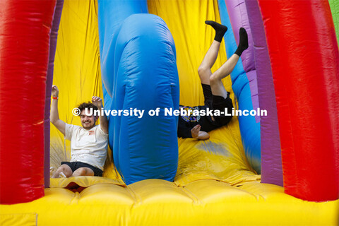 Ronan Parks, a resident assistant in Smith Hall, slides to the finish line of the inflatable obstacl