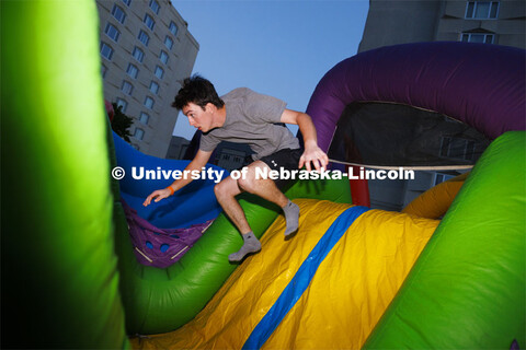 Mason Kusek from Hastings jumps through the inflatable obstacle course at the Block Party at Harper 