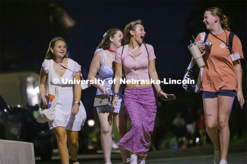 Students in Sorority Recruitment and their Rho Gamma group leader walk back to the suites after a da