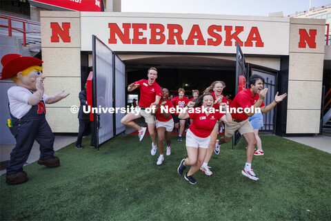 New Student Enrollment leaders charge onto the field as part of the Tunnel Walk into Memorial Stadiu