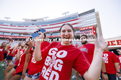 Students are excited as they charge onto the field at the tunnel walk into Memorial Stadium for inco