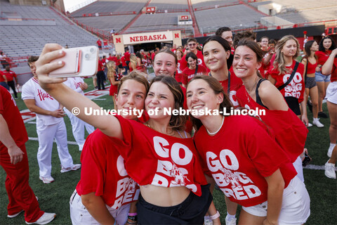 A group stops for a selfie as they enter the field. Tunnel Walk into Memorial Stadium for incoming s