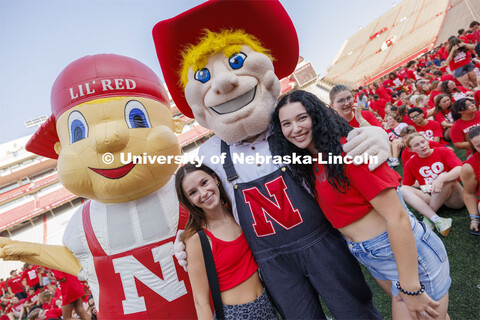 Students pose with Lil' Red and Herbie Husker at the Tunnel Walk into Memorial Stadium for incoming 