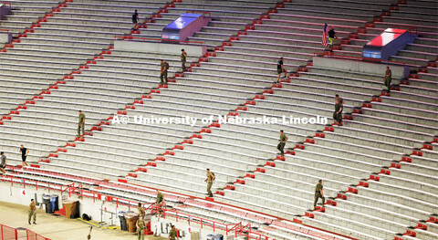 Navy and Marine members climb the east stadium steps. 9/11 stair climb in Memorial Stadium to commem