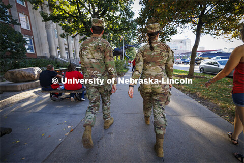 Air Force ROTC cadets Mason Beck, left, and Elena Burgwald walk toward Memorial Stadium an hour and 