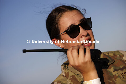 Air Force ROTC cadet Elena Burgwald communicates with the F-16 flight crew doing the flyover. Nebras